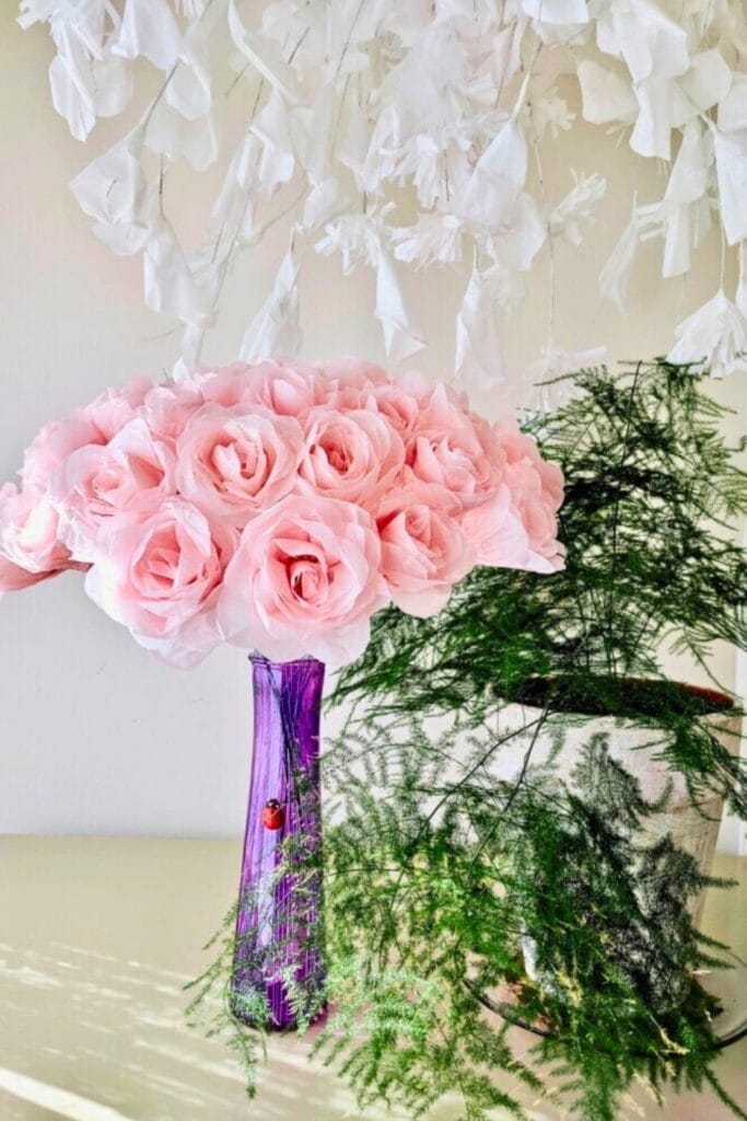 pink paper roses in purple vase -blooming archives