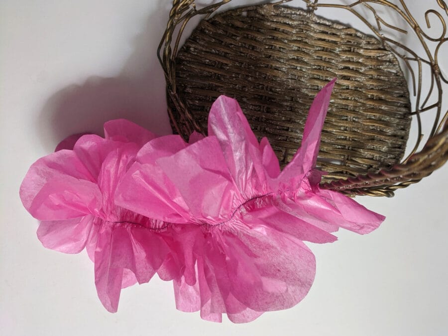pink double-edged tissue ruffles has a seam line at the centre with scalloped borders